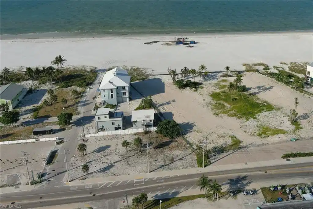 Image 1: Aerial overview of property's location featuring extended coastline