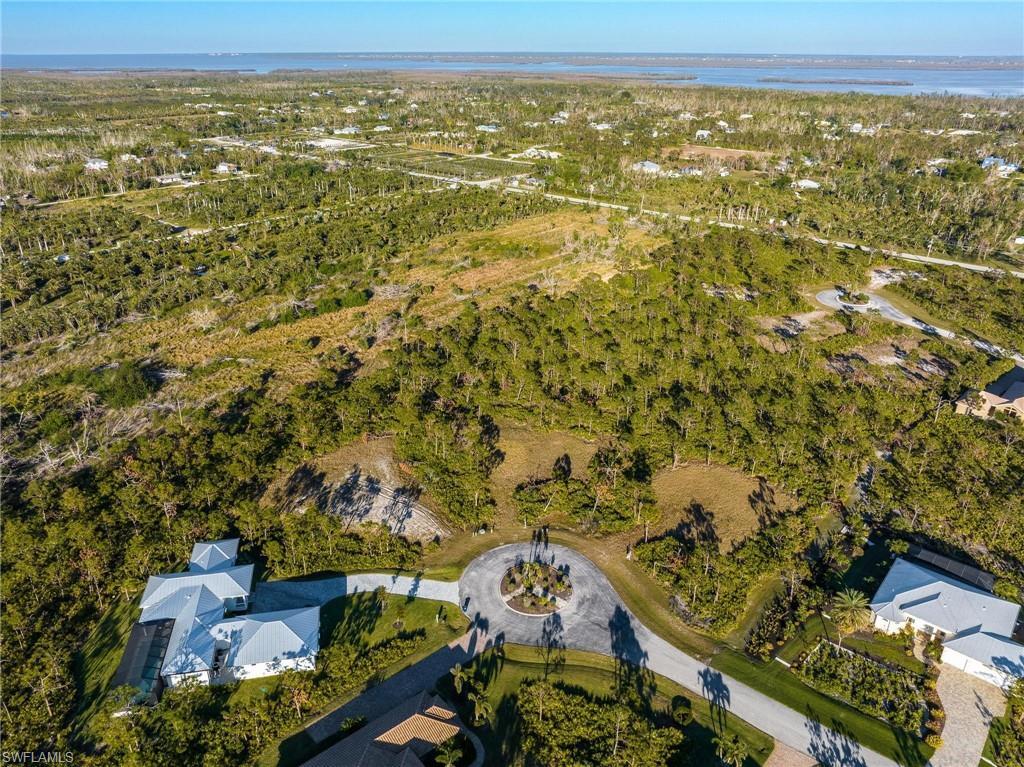 Image 3: Aerial view of property and surrounding area with a nearby body of water
