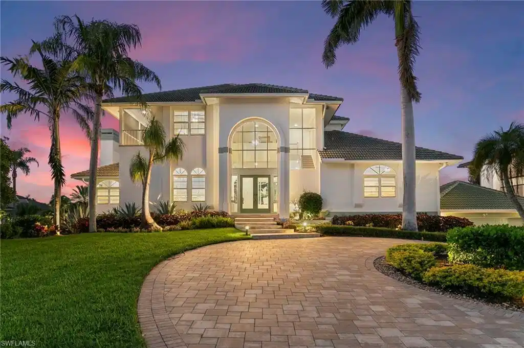 Image 1: Mediterranean / spanish-style house with stucco siding, a yard, french doors, and a tiled roof