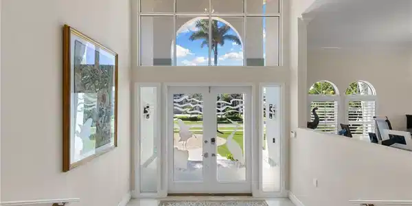 Image 3: Foyer entrance featuring french doors and light marble finish floors