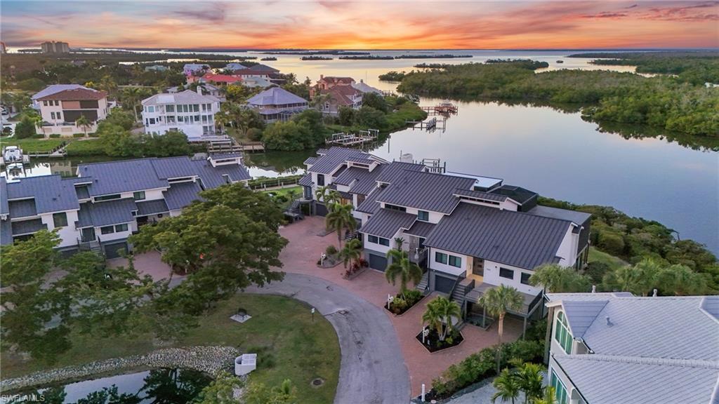 Image 4: Aerial view at dusk of a water view and a residential view