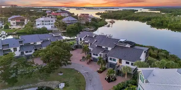 Image 4: Aerial view at dusk of a water view and a residential view