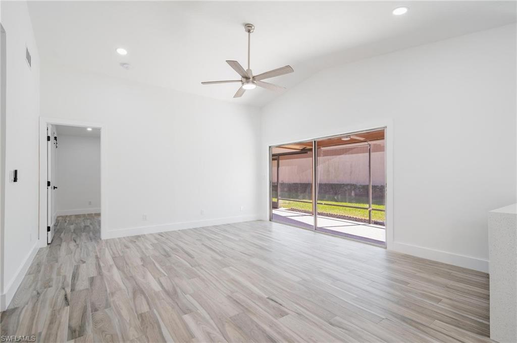 Image 3: Unfurnished room with lofted ceiling, a ceiling fan, light wood-style floors, and recessed lighting