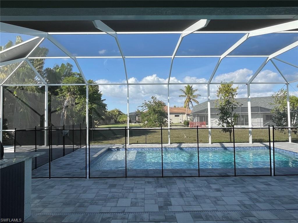 Image 4: Outdoor pool with a lanai and a patio