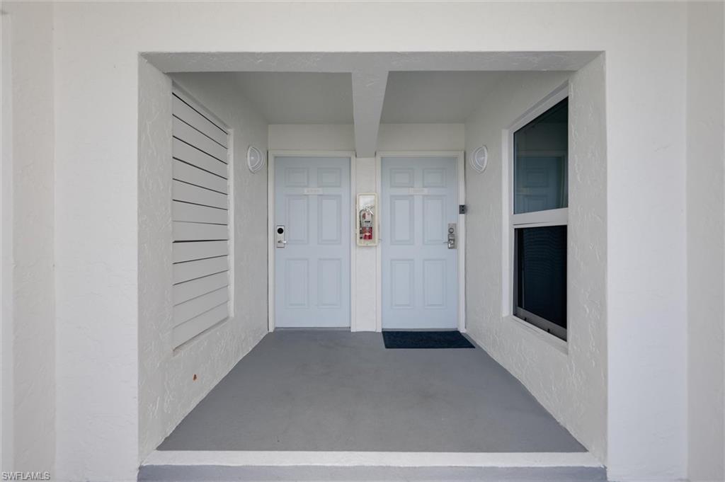 Image 3: Entrance to property with covered porch and stucco siding