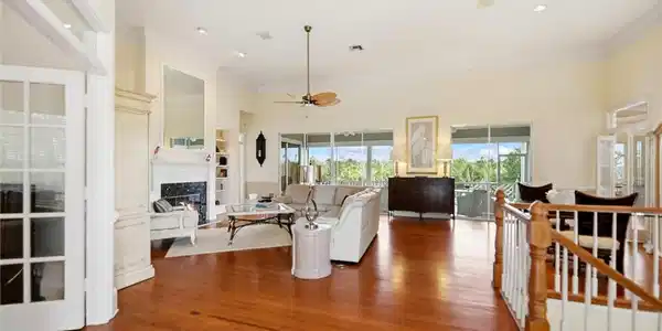 Image 3: Living room featuring a fireplace, plenty of natural light, ceiling fan, wood finished floors, and ornamental molding