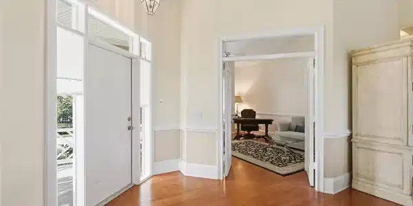 Image 4: Foyer with wood finished floors and hanging lights