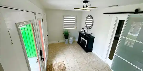 Image 3: Foyer featuring light tile patterned flooring and baseboards