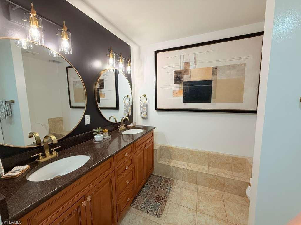 Image 4: Bathroom featuring double vanity and light tile patterned floors