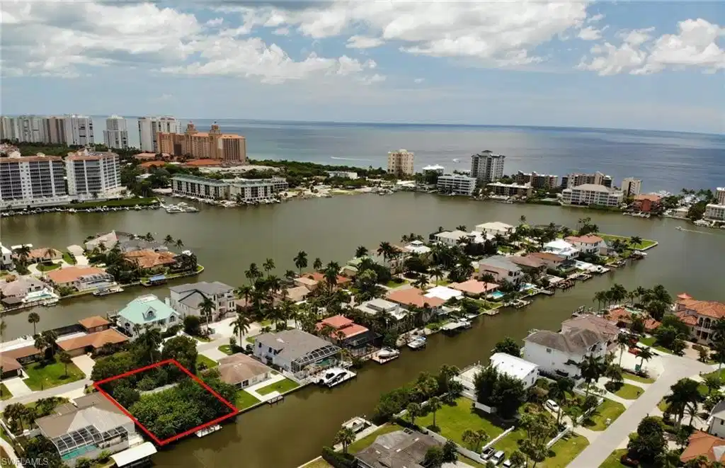Image 1: View of urban area featuring property parcel outlined and a large body of water