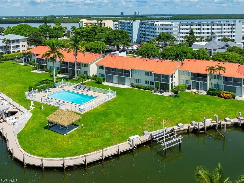 Image 1: Aerial view of a large body of water and a pool