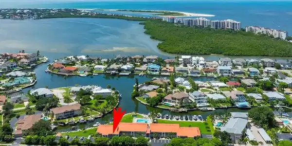 Image 3: Aerial view of residential area with a large body of water