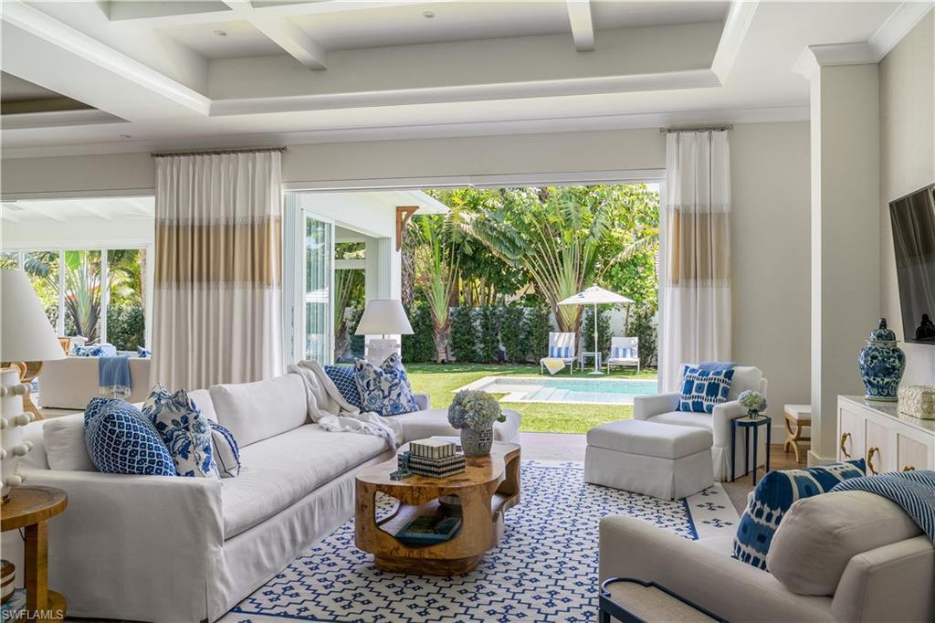 Image 3: Living room featuring healthy amount of natural light, beam ceiling, and coffered ceiling