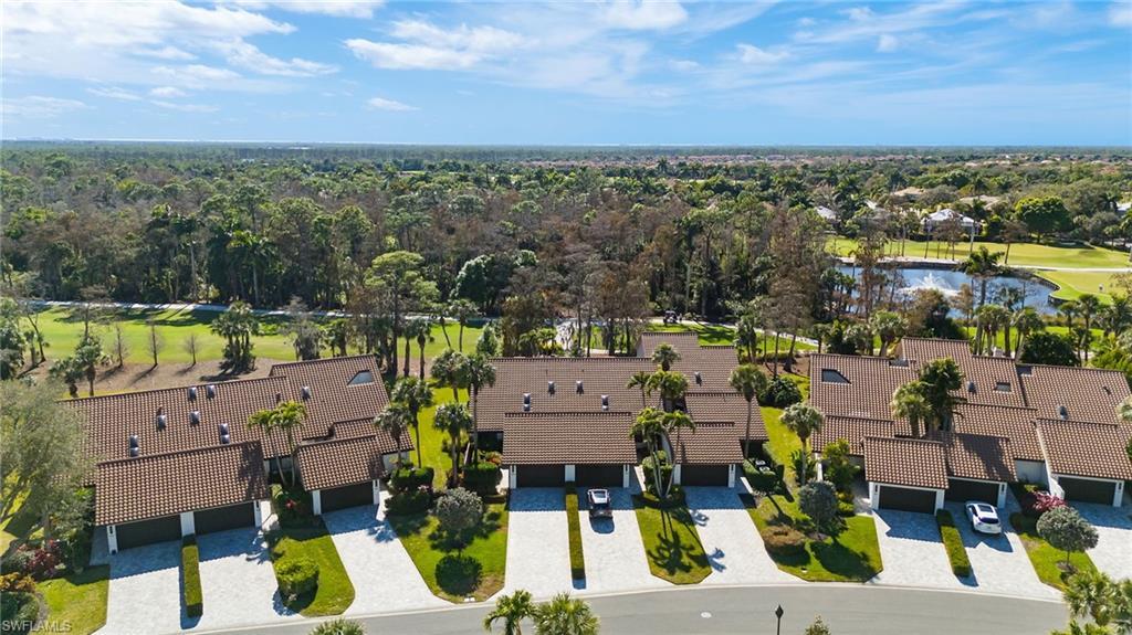 Image 1: Aerial perspective of suburban area featuring a golf course