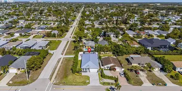 Image 4: Aerial view of property's location featuring nearby suburban area