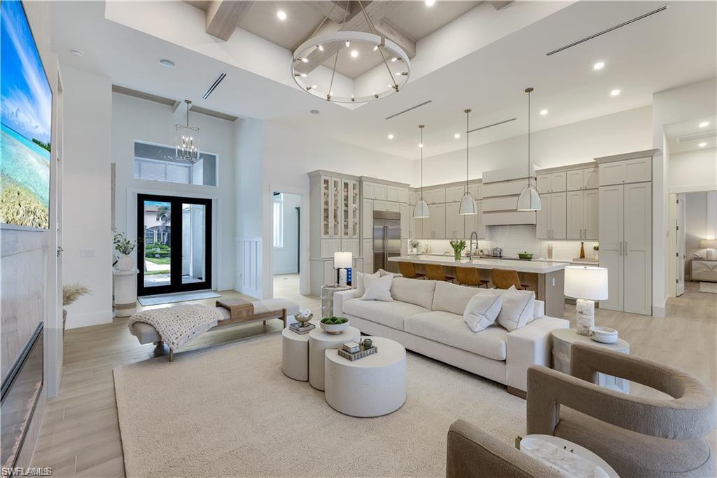 Image 4: Living room with light wood finished floors and recessed lighting
