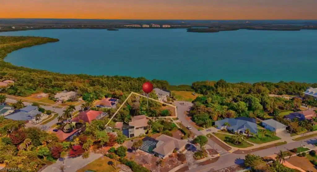 Image 1: Aerial view of residential area featuring a large body of water