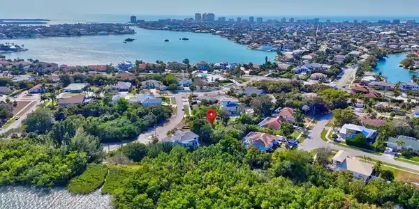 Image 2: Aerial view of residential area featuring a large body of water