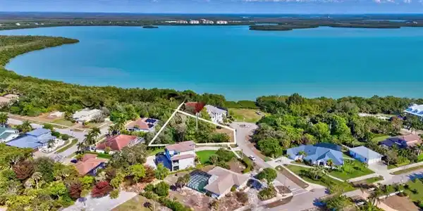 Image 3: Aerial view of residential area featuring a large body of water