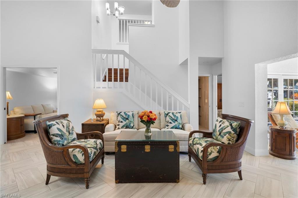Image 3: Living room with a high ceiling and a chandelier