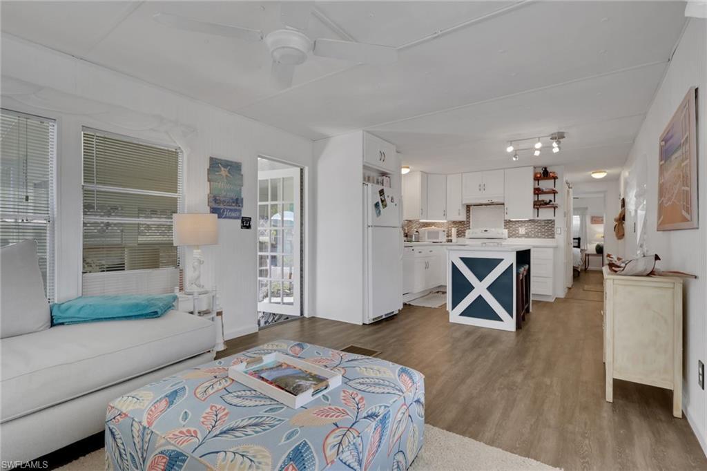 Image 3: Living area with light wood-style flooring and ceiling fan