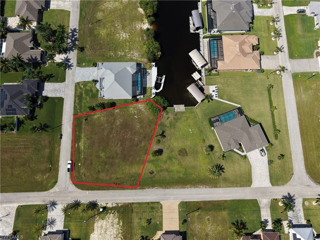 Image 1: Aerial view of residential area with property parcel outlined