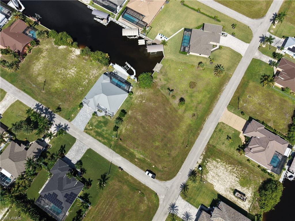 Image 4: Aerial perspective of suburban area with a nearby body of water