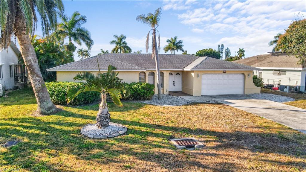 Image 3: Ranch-style house double door entry, newer roof. concerte block construction with stucco exterior finish, concrete driveway, a oversized 2 car garage and new roof.