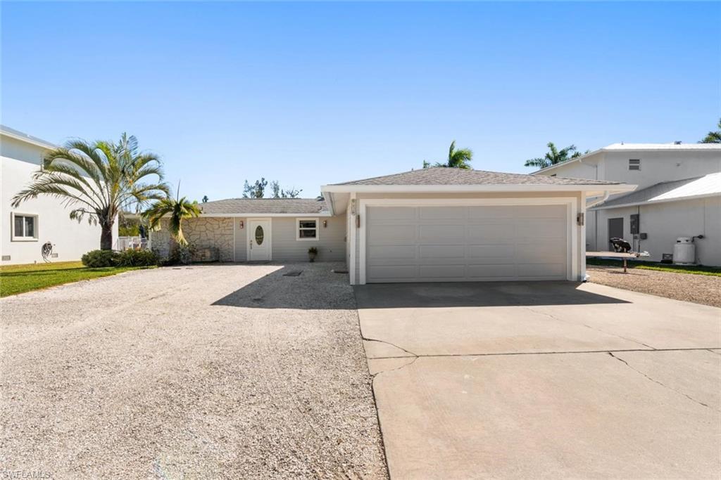 Image 2: Ranch-style house featuring concrete driveway and an attached garage