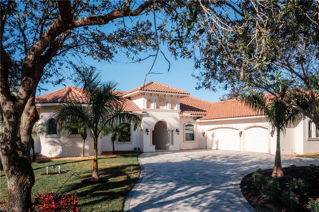 Image 4: Mediterranean / spanish home featuring decorative driveway, an attached garage, stucco siding, and a tiled roof