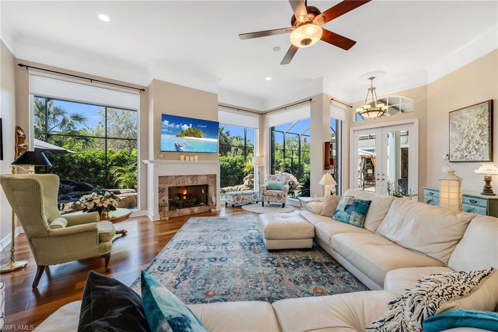 Image 2: A large space with gas fireplace, large windows to gaze out to private oasis pool to preserve.