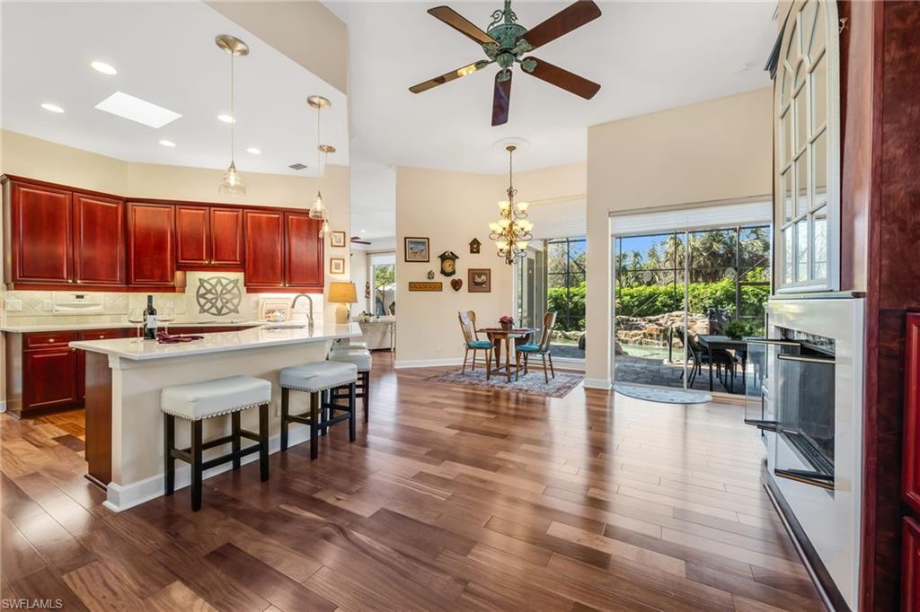 Image 4: Kitchen has quartz countertops and opens to Breakfast area with two set of slider doors to allow the outside in concept.  Gas Fireplace for the few cool days of Florida.
