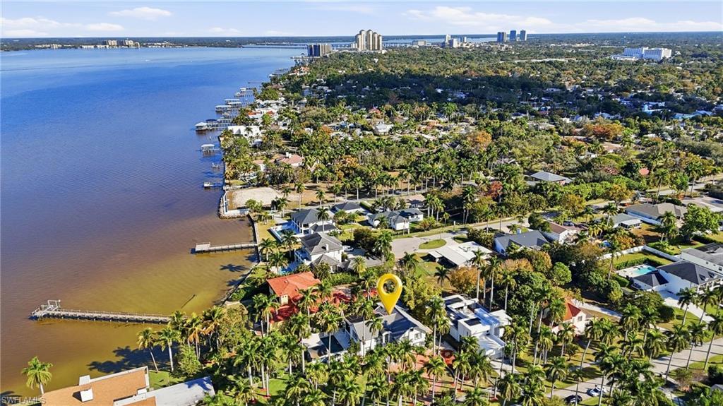 Image 3: Aerial perspective of suburban area with a large body of water
