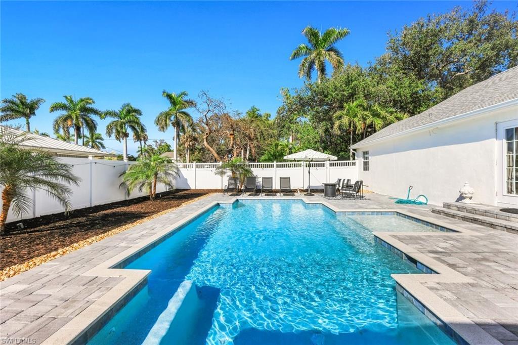 Image 1: View of swimming pool featuring patio surround and a fenced backyard