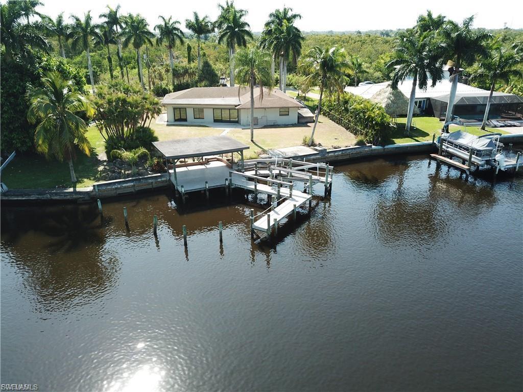 Image 1: Dock with boat lift and a water view