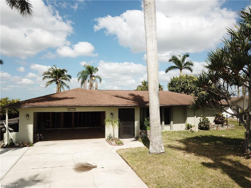 Image 4: Ranch-style home featuring concrete driveway, a garage, a front yard, and stucco siding