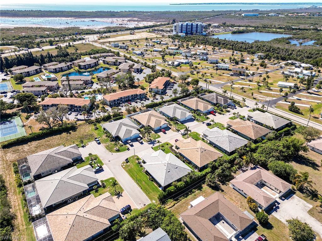 Image 2: Aerial view of property and surrounding area with a large body of water and nearby suburban area