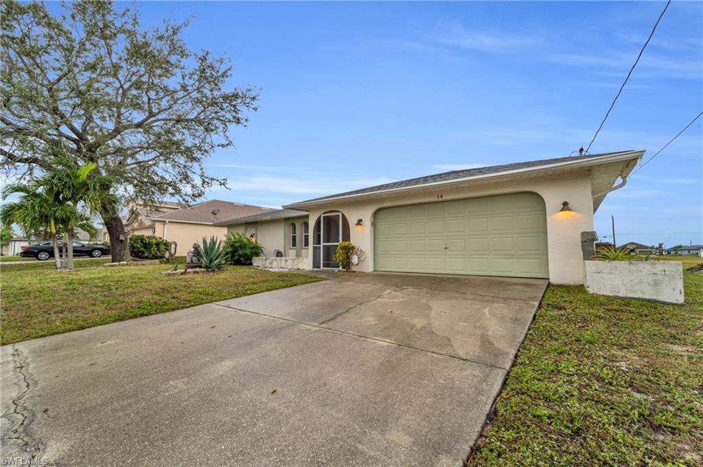 Image 3: Single story home with a front lawn, stucco siding, concrete driveway, and an attached garage