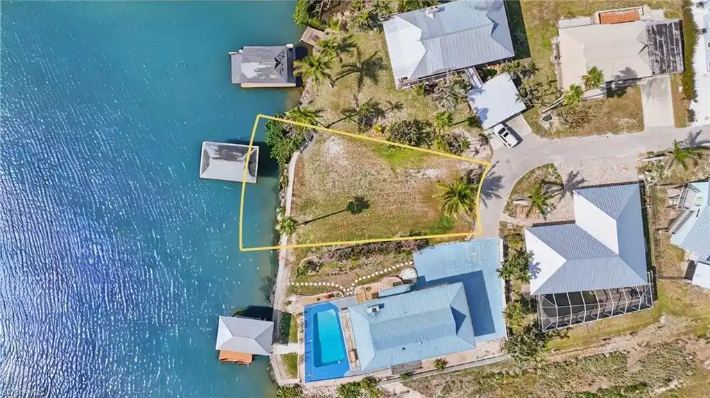 Image 1: Drone / aerial view of a pool and a large body of water-  VIRTUALLY ENHANCED