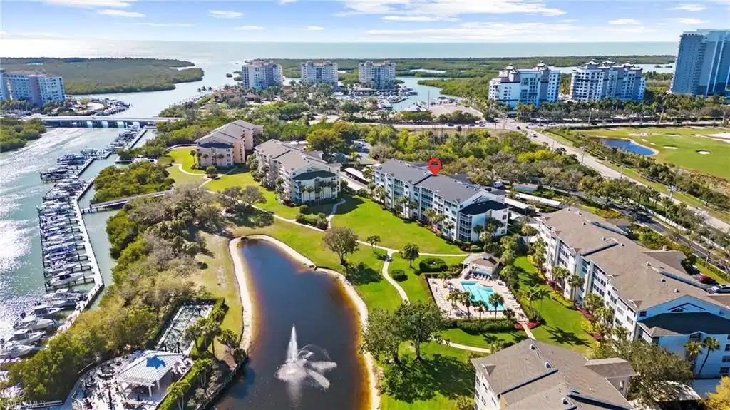 Image 1: Drone / aerial view of a nearby body of water and apartment complex