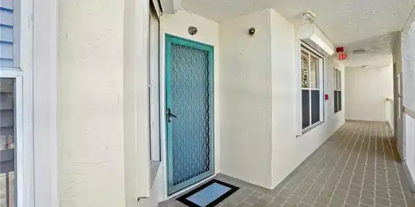 Image 4: Entrance to property featuring stucco siding