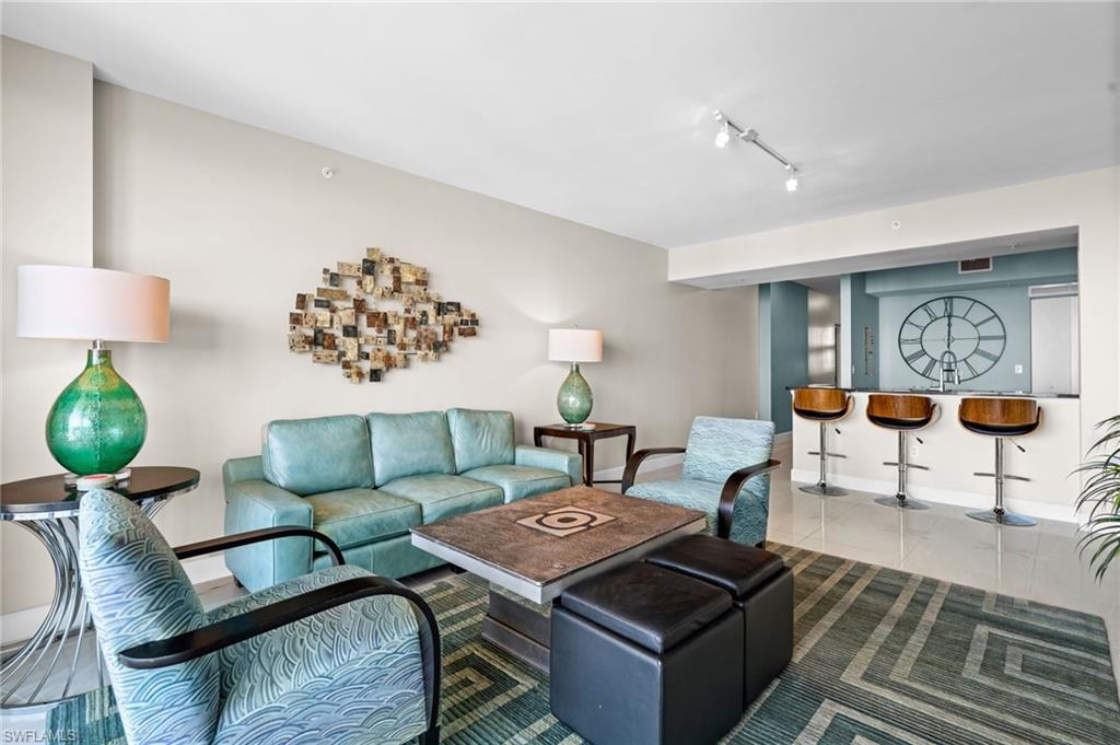 Image 3: Living area with rail lighting and tile patterned floors