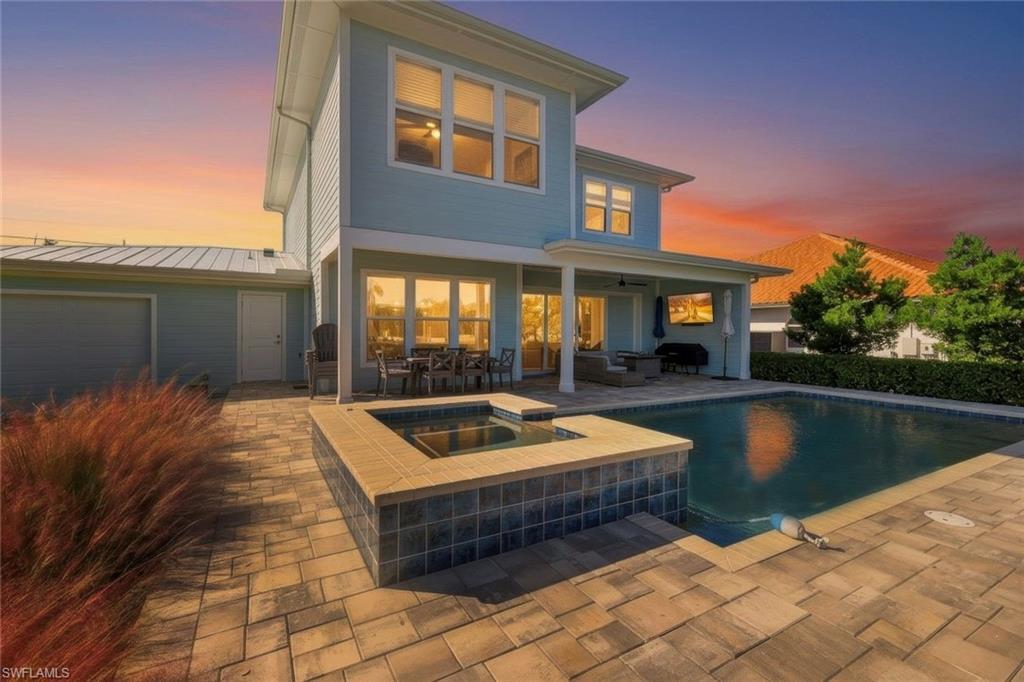 Image 4: Enjoy breathtaking sunsets while relaxing by the pool or entertaining on the spacious lanai.