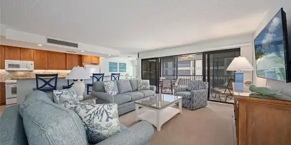 Image 2: Living room with light carpet, a textured ceiling, and a ceiling fan