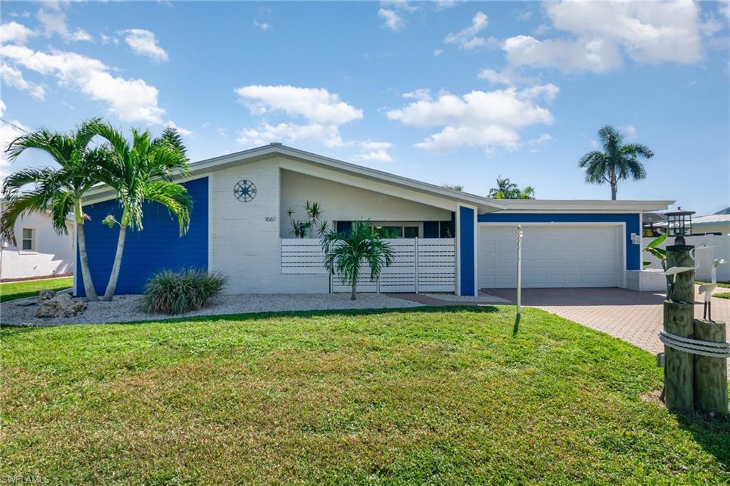 Image 3: Traditional Florida-style home on the outside; elegantly updated home on the inside.