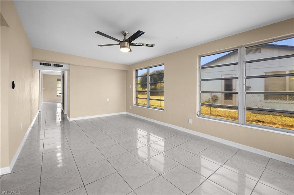 Image 4: Unfurnished room featuring light tile patterned flooring and a ceiling fan