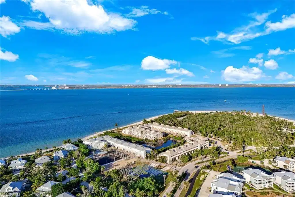 Image 1: Aerial view of residential area featuring a large body of water