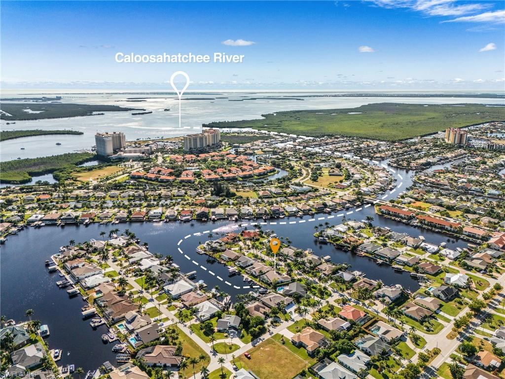 Image 1: Aerial view of property's location with a nearby body of water and nearby suburban area