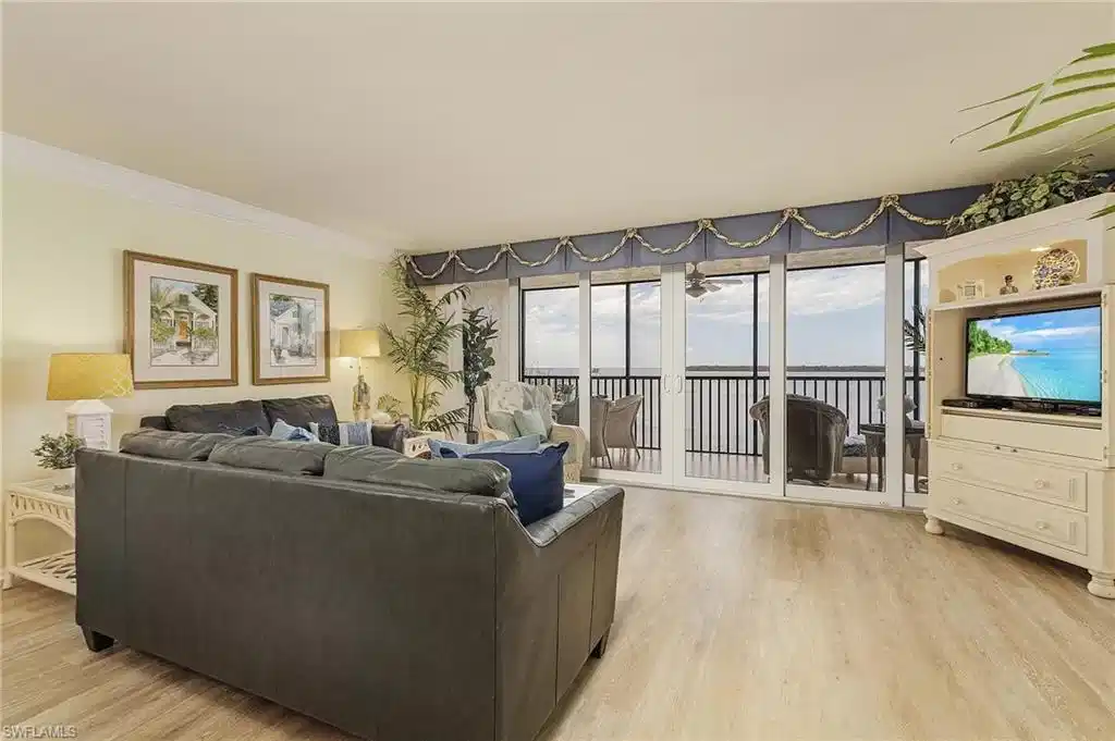 Image 1: Living room featuring ornamental molding and light hardwood / wood-style flooring