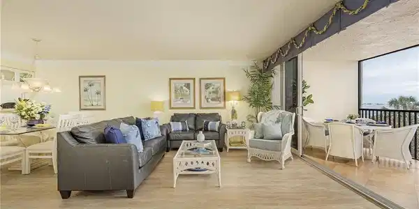 Image 4: Living room with light hardwood / wood-style floors, crown molding, and a chandelier